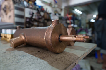 Brass air pump cylinder parts ready for assembly in industrial machinery factory