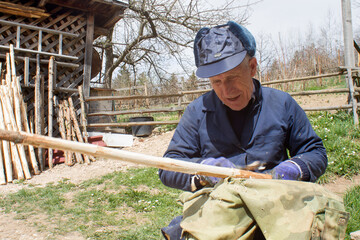 Man makes something from wood