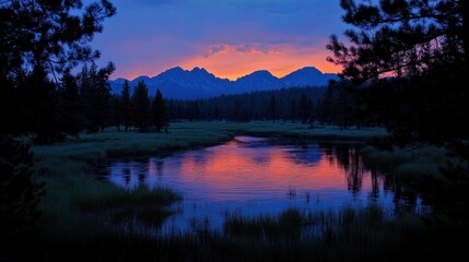 Fototapeta premium Serene twilight landscape with mountains reflecting in a tranquil river.