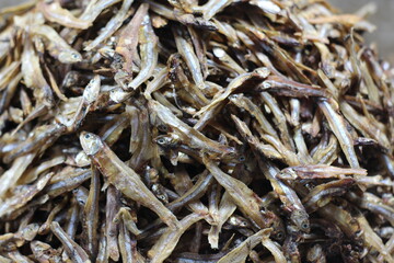 Fresh salted fish in Indonesian traditional market, small fish dried in salt. Dried fish is full of calcium for healthy bones. Assorted small dried fish in market. Dried fish stored for selling.