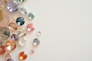 Collection of colorful sparkling crystals arranged on a light background for decorative purposes
