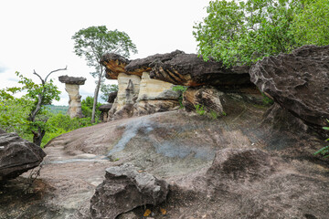 Pha Taem National Park, Ubon Ratchathani, Mekong River, see prehistoric paintings on the cliff, strangely shaped stone pillars and a small field of colorful flowers in late rainy season, early winter.