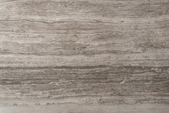 Beige stone surface with horizontal vein patterns and natural texture