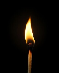 A closeup of a wooden match with a flickering, bright flame burning brightly, contrasting with the dark black background for dramatic effect
