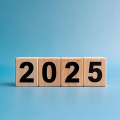 An arrangement of wooden blocks displaying the year 2025 on a blue surface, symbolizing a futuristic concept or marking a specific year.
