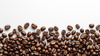 Roasted coffee beans scattered on white background.