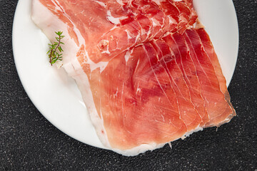 Jamon meat iberico or serrano snack aperitif fresh tasty food dish delicious gourmet food background on the table rustic food top view copy space