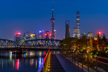 Fototapeta premium Sunset of Shanghai city modern skyscraper night light cityscape in twilight blue sky in autumn season behind pollution haze, view from the bund in Shanghai, China.