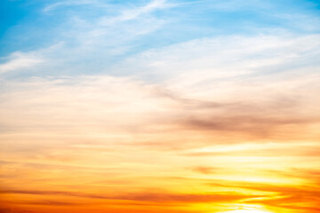 Obraz premium Sky,sunset, beautiful , luxury soft gradient orange gold clouds and sunlight on the blue sky perfect for the background, Sunrise on morning or everning in winter warm time ,Twilight summer,silhouette