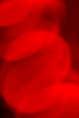 Abstract red bokeh background. Defocused  lights. Party, holiday and festive concept