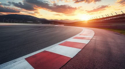 Gordijnen A race track with a red and white line on the road. The sun is setting in the background © Bambalino Studio