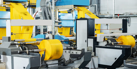 Polyethylene plastic bag production, sunlight. Closeup roller of industry machine for packaging