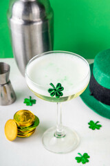 Patrick day alcohol bar drinks menu, party invitation, gold green cocktail garnished with shamrock, green sugar sprinkles, for St. Patrick's Day celebrations, with festive decor and bar utensils
