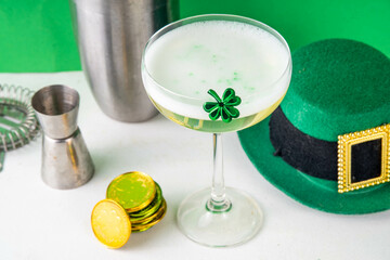 Patrick day alcohol bar drinks menu, party invitation, gold green cocktail garnished with shamrock, green sugar sprinkles, for St. Patrick's Day celebrations, with festive decor and bar utensils