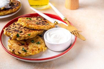 Vegetarian comfort food, potato pancakes. Traditional european vegetable dish, potato fritters, cutlets, latkes (flapjacks, hash brown or potato vada) with sour cream