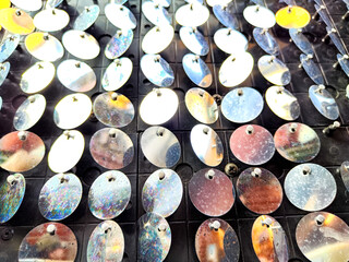 Reflective metal discs arranged in a pattern, suitable for text placement or decorative background...