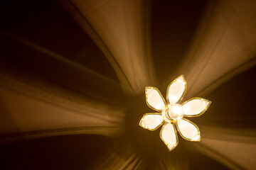 Old chandelier with incandescent lamp on the ceiling