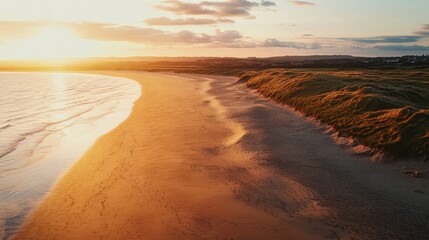 Obraz premium Stunning Sunset Over a Serene Beach with Gentle Waves and Sandy Shore