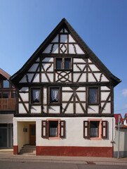 A half-timbered wooden residential house with its symmetrical gable in the old village of Hüffelsheim, Rheinland-Pfalz in Germany