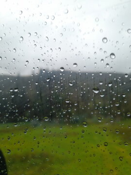 raindrops on the window showing a blurred landscape