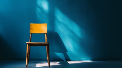Shadow of a chair cast on a blue wall with soft studio lighting, highlighting the interplay of light and shadow in a minimalist artistic interior design setting.