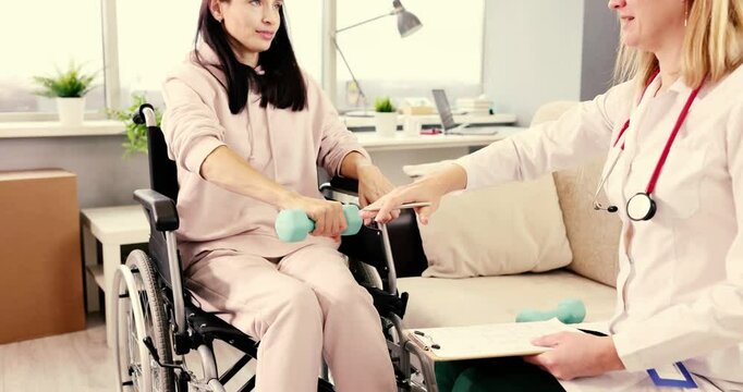 A therapist expertly assists a patient who uses a wheelchair with physical therapy exercises that involve weights