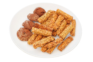 Gozinaki and cookies in a plate. Isolate on white background. Homemade seed sunflower candies. Sweet granola in plate for holiday.