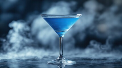 Blue cocktail in martini glass with smoke.
