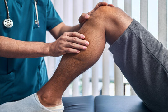 physiotherapist massaging the knee of a patient. patient rehabilitation and recovery after physical knee injuries in recovering from Injury physiotherapy massage of sportsman 