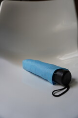 Small blue umbrella on a white background