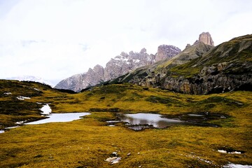 Partly snow-covered mountain landscape in the European Alps and the Italian Dolomites. Mountain...