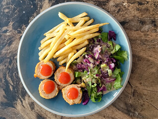 Traditional French cuisine, crispy and tender chicken cordon bleu accompanied by French fries and...