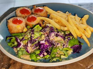 Traditional French cuisine, crispy and tender chicken cordon bleu accompanied by French fries and...