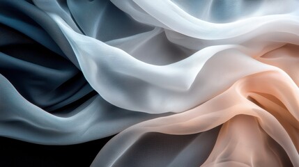 Soft, flowing fabric in shades of blue, white, and pink, creating an elegant and textured appearance against a dark background.