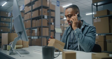 Warehouse of postal service or E-commerce store: African American logistics coordinator talks by...