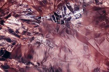Texture of glossy polyethylene plastic sheet material crumpled and wrinkled