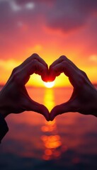 Fototapeta premium Close-up hands form heart, vibrant sunset background , gesture, couple
