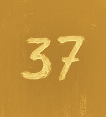 Number 37 on aged background. Thirty seven on textured surface