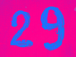 Number 29 on pink background. Twenty-nine on textured surface 