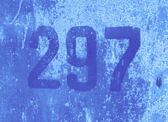 Number 297 on aged blue background. Two hundred and ninety-seven on textured surface