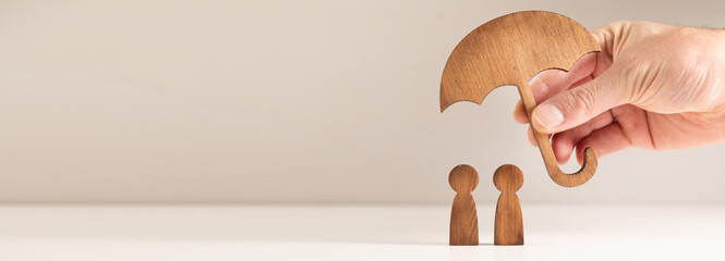 hand holding wooden figure on a white background