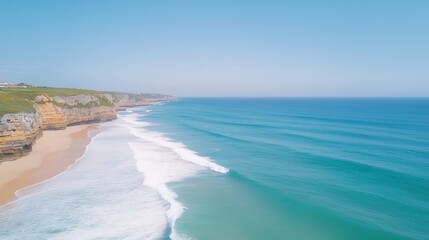 Aerial view of a coastal landscape with turquoise ocean waves, sandy beach, and rocky cliffs under a clear blue sky Scenic seascape and travel concept for nature and vacation design