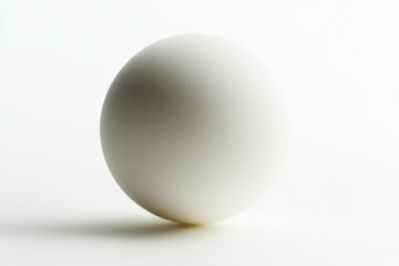 Lone white ping pong ball against white background