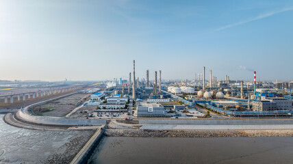 Aerial panorama of a chemical industrial plant and harbor on clear day