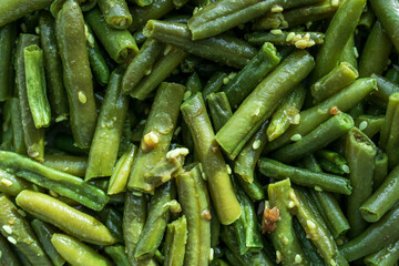 A close-up of sliced green beans is randomly positioned on the surface