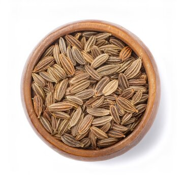 Wooden bowl filled with cumin seeds, top down view, white backdrop showcasing rustic spice texture and warm brown coloring