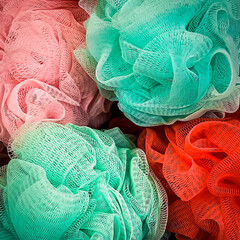 Red, pink, and green lace mesh bath scrubber