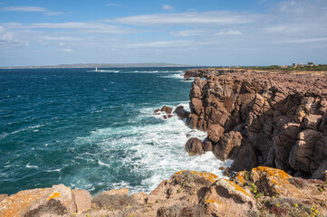The beautiful high red cliffs of Nido dei Passeri on the island of Sant'Antioco in Sardinia