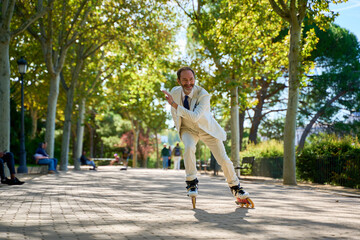 Man roller skating with a cheerful expression in a park