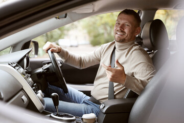 Man driving modern car, view through window